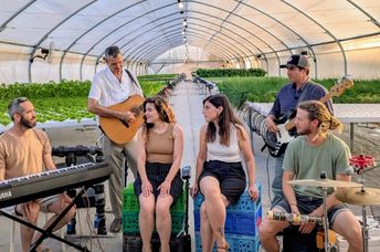 Hashayara plays music in a greenhouse.