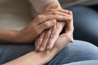 Two people hold hands.