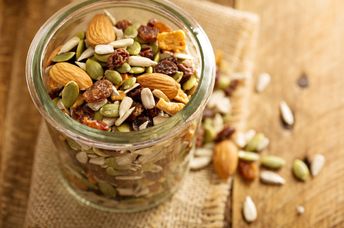A jar filled with seeds and nuts.