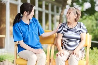 A young Japanese woman in a discussion with a grandma figure.