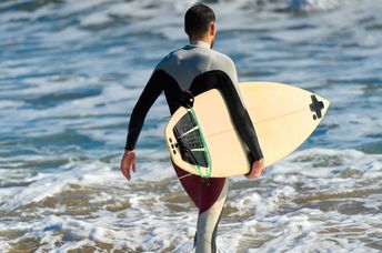 Surfer wearing a wetsuit.