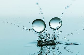 Gel balls falling against a blue background.
