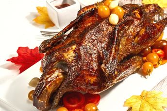 Serve a roasted duck for an authentic Thanksgiving experience.