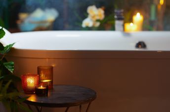 A bathroom with warm and dim candles.