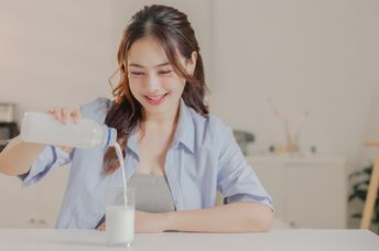 Enjoying a glass of vegan dairy-free milk.