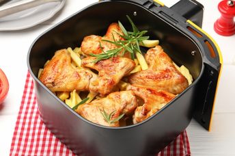 Cooking chicken wings in an air fryer.