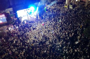 Aerial night view of thousands gathered in Tel Aviv’s Hostages Square.