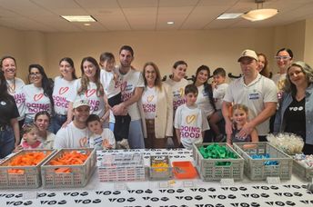 Shari Arison stands with Good Deeds Day volunteers.