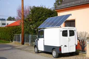 A car with a solar panel battery on the roof.