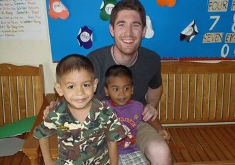 Christian Clark with children at daycare in Thailand (courtesy of Projects Abroad)