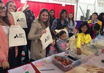 Simply the Basics volunteers help package hygiene kits. (Simply the Basics)