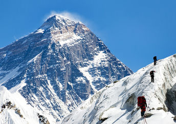 View of Everest from Gokyo valley with a group of climbers on a glacier on their way to Everest base camp