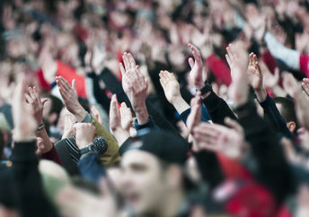 Fans of the University of Iowa football team wave at children at the University of Iowa wave at children at the Stead Family Children's Hospital across from the stadium