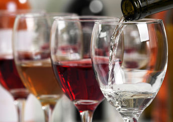 Wine being poured into wine glasses