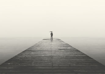 business man with umbrella looking at the horizon