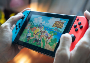 Man playing Animal Crossings on Nintendo Switch.