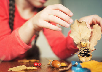 Child painting pinecones