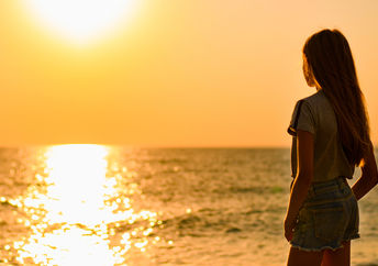 Girl at sunset near water