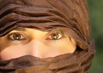 Veiled woman working outdoors