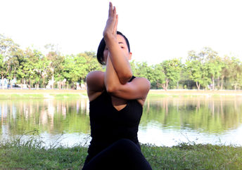 Woman in eagle yoga pose.