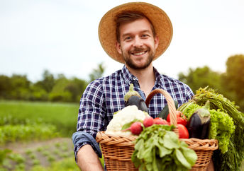 Young farmer holding crops