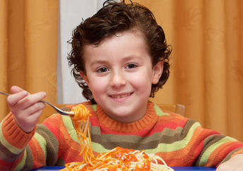 This boy is eating a healthy and nutritious kid-friendly meal.