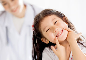 Happy girl with kind doctor