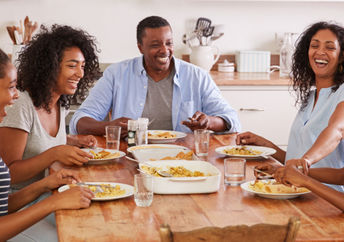 A family eating together promotes health benefits.