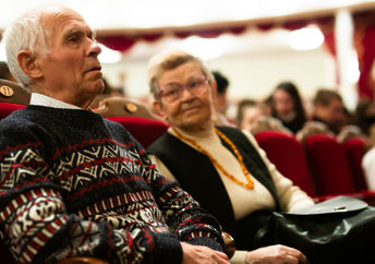 Senior couple enjoying performance at opera and ballet theater.