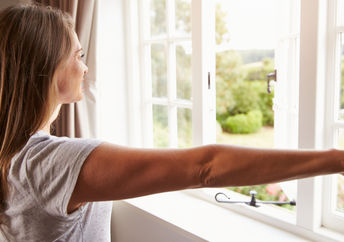 Woman thinking about her goals by a window