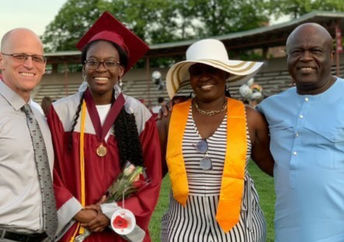 Verda Tetteh poses in her graduation gown with family and her school principal.