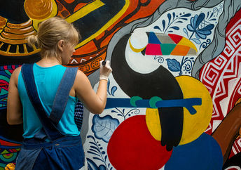 Woman painting street art.