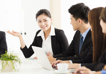 Japanese workers at a meeting look happy and more refreshed, an outcome of a 4 day work week.