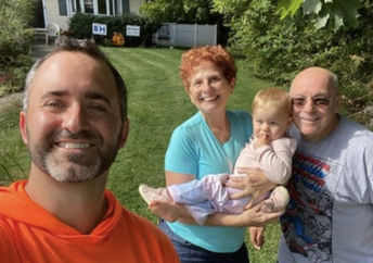 Brian Schwartz with happy senior citizens and their grandchild.