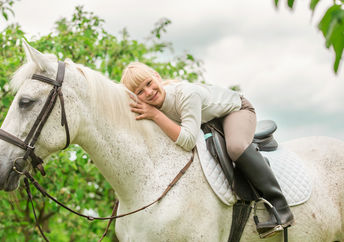 Girl getting pet therapy with a horse.