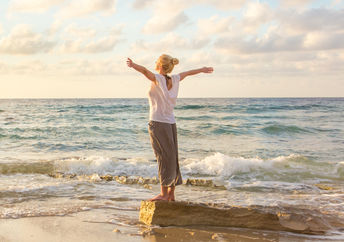 A calm and relaxed woman at the beach.