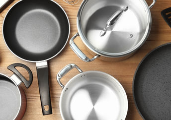 A selection of kitchen cookware including pots, pans, and utensils.