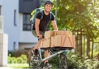 Bicycle messenger making a delivery on a cargo bike