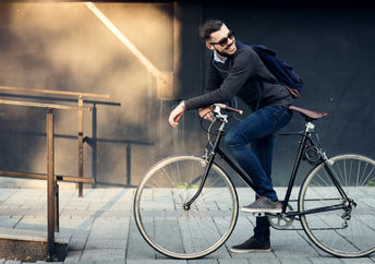 Cyclist heading to work in town center