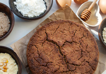 A selection of gluten-free flours beside a healthy freshly baked muffin.