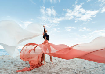 Classic dancer at the beach with long, flowing fabric