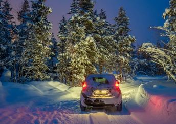 Car traveling on a snowy road.