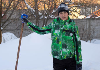 Teen shoveling snow.