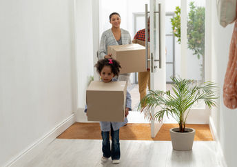 Front view of happy family entering their new home.