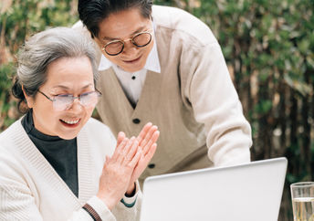 Senior couple using a laptop to code