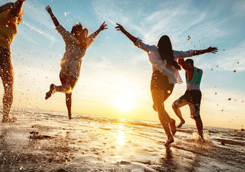 Four happy friends enjoying the beach.