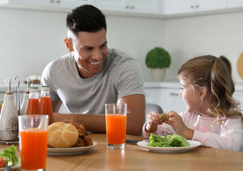 Father and daughter enjoying a healthy breakfast together.