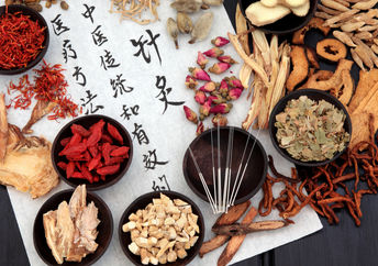 Traditional Chinese medicine herbs, and acupuncture needles.
