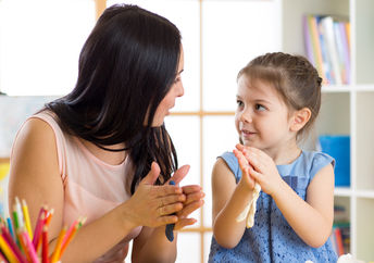 Mother and her daughter deep in conversation while doing art.