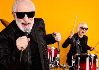 Portrait of cheerful seniors enjoying playing music.